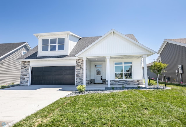 662 Rania Way W, West Fargo, ND 58078 - view of front of house featuring stone siding, a porch, and concrete driveway