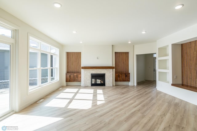 662 Rania Way W, West Fargo, ND 58078 - unfurnished living room featuring light wood-type flooring, recessed lighting, and a fireplace