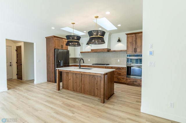 662 Rania Way W, West Fargo, ND 58078 - kitchen featuring black fridge, a skylight, gas cooktop, double oven, and light countertops