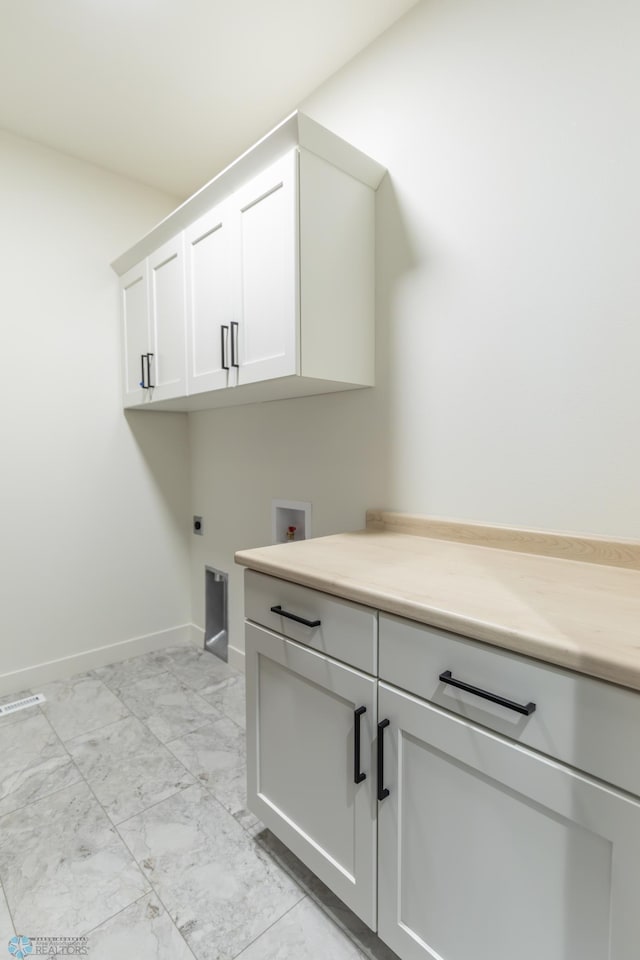 662 Rania Way W, West Fargo, ND 58078 - laundry room with cabinet space, hookup for a washing machine, hookup for an electric dryer, and light marble finish flooring