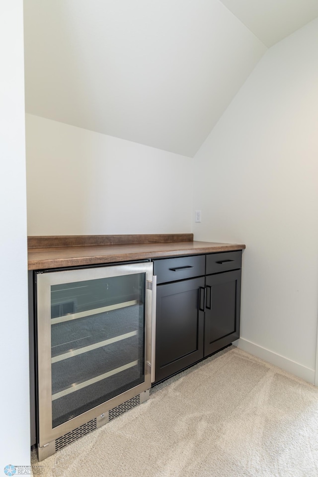662 Rania Way W, West Fargo, ND 58078 - indoor dry bar with wine cooler, vaulted ceiling, and light colored carpet