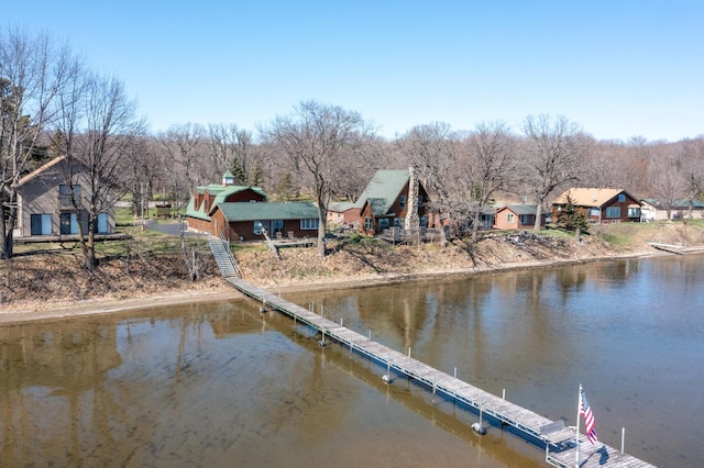 view of dock with a residential view and a water view