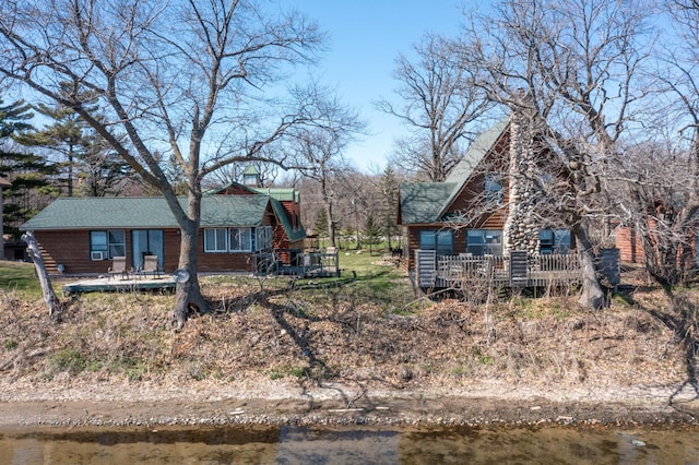exterior space featuring a deck with water view