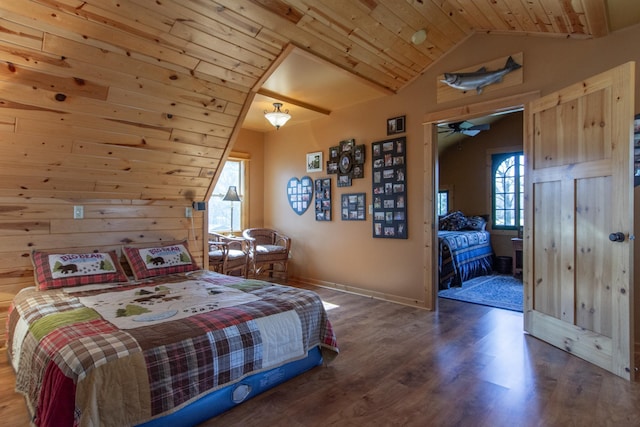 bedroom featuring wood walls, wood finished floors, lofted ceiling, baseboards, and wood ceiling