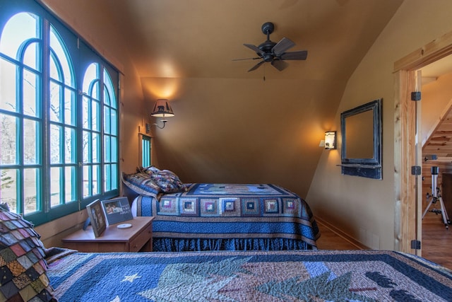 bedroom featuring baseboards and lofted ceiling