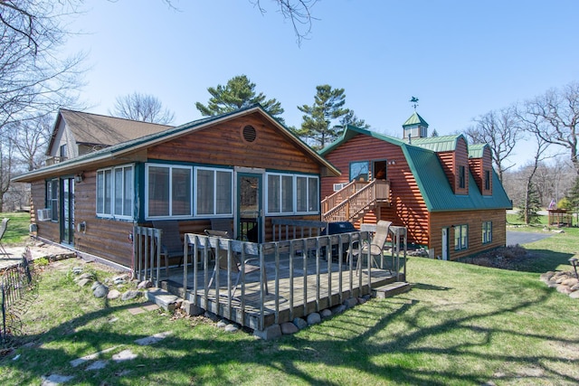 back of property featuring a yard, a deck, a chimney, and stairs