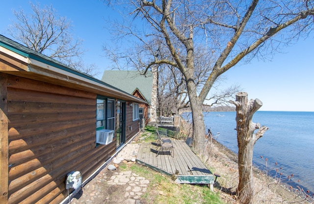 exterior space with a deck with water view and cooling unit