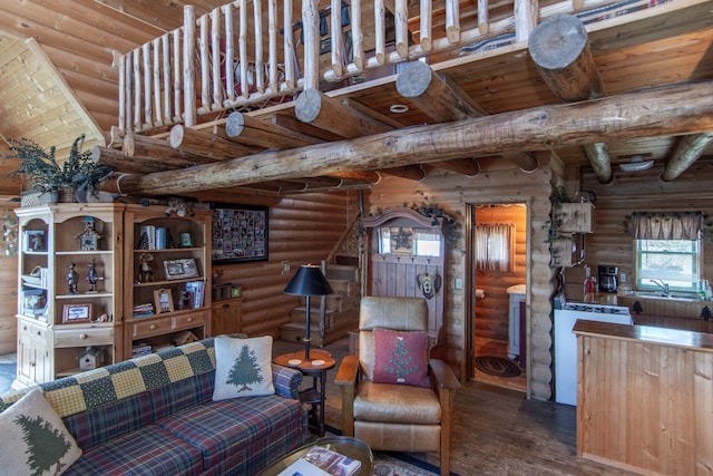 living room featuring rustic walls, wood finished floors, beam ceiling, washer / clothes dryer, and wood ceiling
