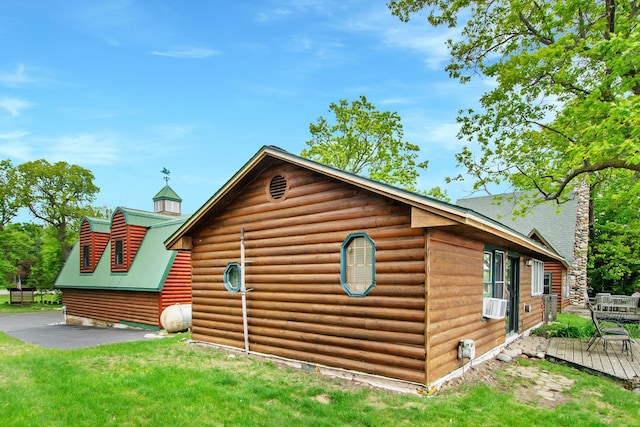 21594 452nd Pl, Aitkin, MN 56431 - view of side of home featuring a wooden deck, a yard, faux log siding, and cooling unit
