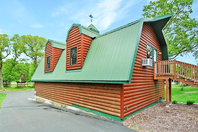 21594 452nd Pl, Aitkin, MN 56431 - view of side of property featuring a gambrel roof, metal roof, stairway, and cooling unit