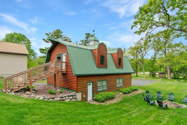 21594 452nd Pl, Aitkin, MN 56431 - view of side of property featuring a gambrel roof, stairway, and a lawn