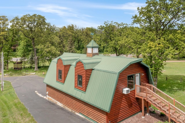 21594 452nd Pl, Aitkin, MN 56431 - view of side of home with a gambrel roof, metal roof, a lawn, and a chimney