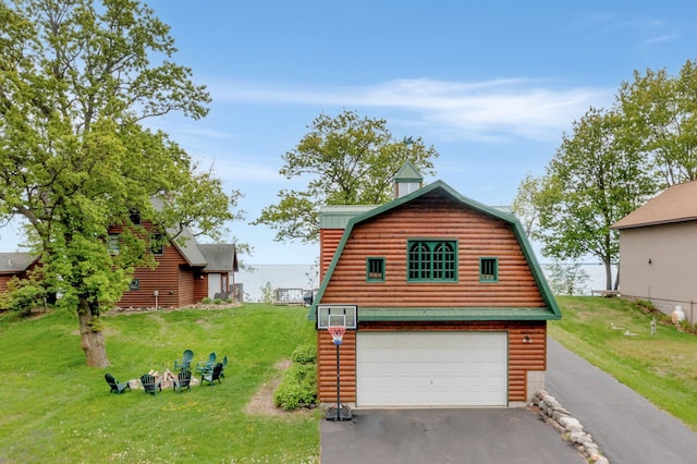 21594 452nd Pl, Aitkin, MN 56431 - view of front of house with asphalt driveway, a front lawn, an attached garage, and a gambrel roof