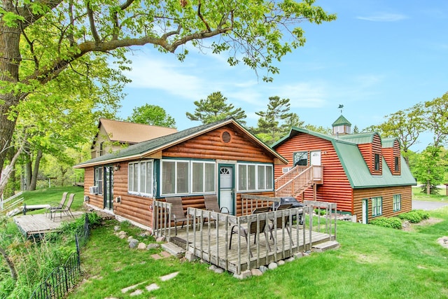 21594 452nd Pl, Aitkin, MN 56431 - rear view of property with a wooden deck, log veneer siding, and a lawn