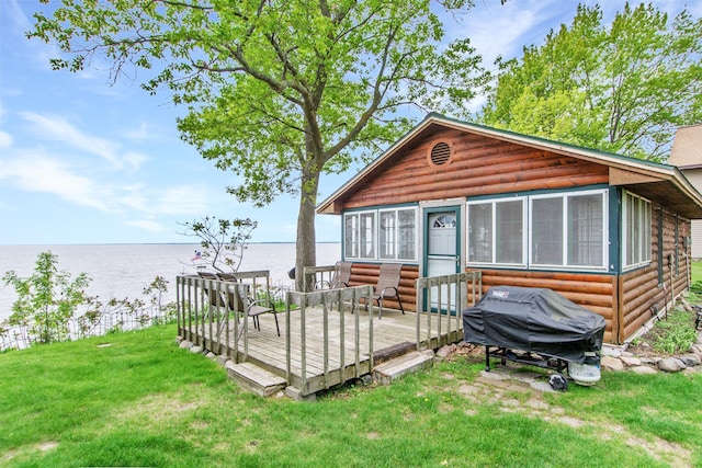 21594 452nd Pl, Aitkin, MN 56431 - rear view of property featuring faux log siding, a deck with water view, and a lawn
