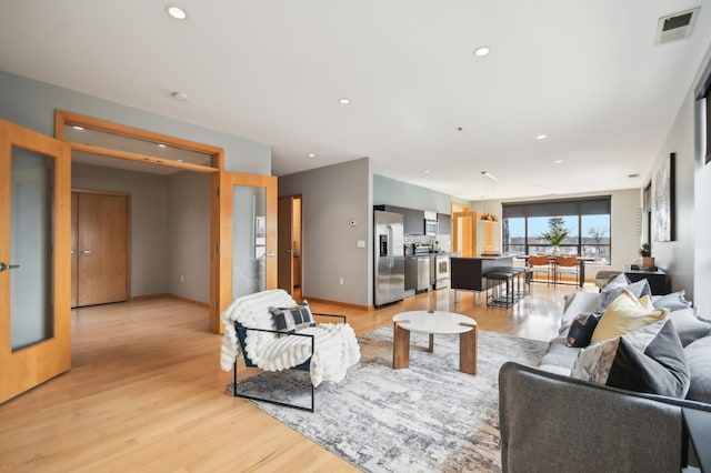 3104 Lake St Unit 202, Minneapolis, MN 55416 - living room with light wood finished floors, recessed lighting, and baseboards