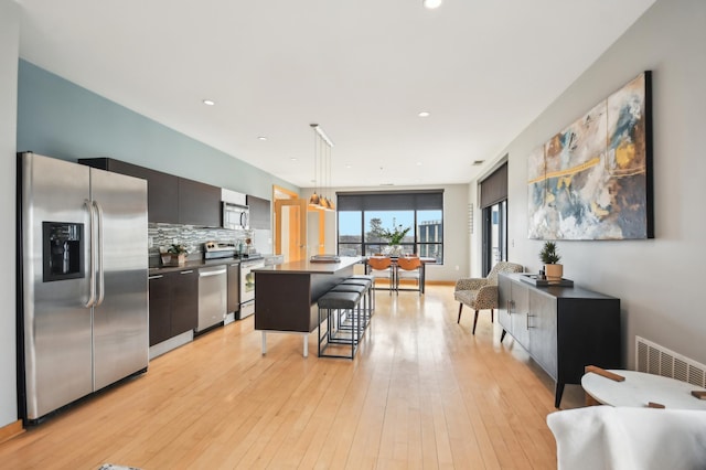 3104 Lake St Unit 202, Minneapolis, MN 55416 - kitchen featuring stainless steel appliances, modern cabinets, a kitchen bar, dark countertops, and decorative backsplash