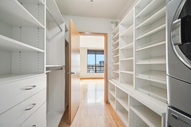 3104 Lake St Unit 202, Minneapolis, MN 55416 - walk in closet with stacked washing machine and dryer and light wood finished floors
