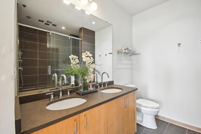 3104 Lake St Unit 202, Minneapolis, MN 55416 - bathroom featuring toilet, a shower stall, double vanity, tile patterned floors, and recessed lighting