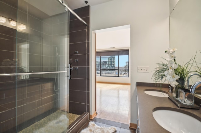 3104 Lake St Unit 202, Minneapolis, MN 55416 - bathroom featuring a shower stall, double vanity, and tile patterned flooring