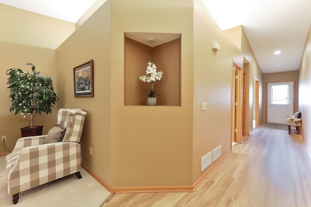 corridor featuring wood finished floors, baseboards, and recessed lighting