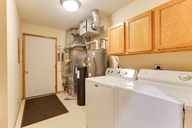 washroom with water heater, cabinet space, washer and clothes dryer, and electric panel