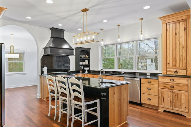 18975 Highland Ave, Deephaven, MN 55391 - kitchen with stainless steel appliances, custom range hood, a sink, a center island with sink, and recessed lighting