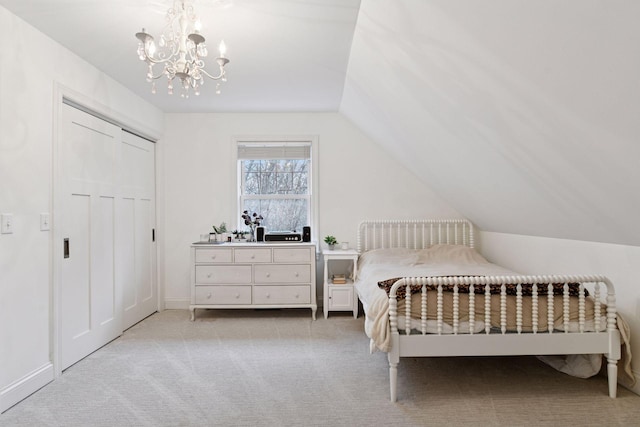 18975 Highland Ave, Deephaven, MN 55391 - carpeted bedroom featuring a chandelier, vaulted ceiling, a closet, and baseboards