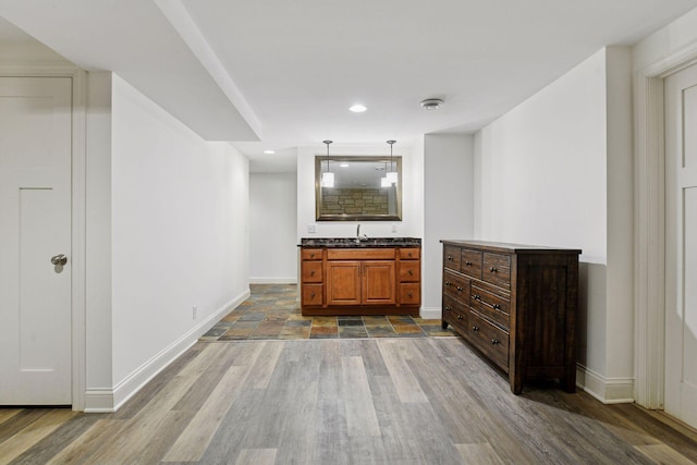 18975 Highland Ave, Deephaven, MN 55391 - bar featuring baseboards, a sink, hanging light fixtures, and recessed lighting