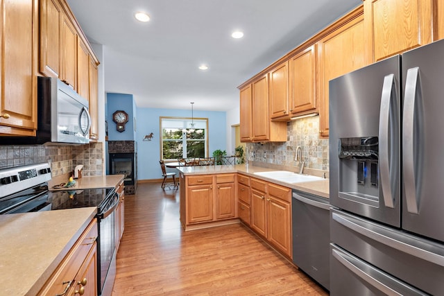 11102 16th St NE, Saint Michael, MN 55376 - kitchen with appliances with stainless steel finishes, light wood-style flooring, recessed lighting, decorative backsplash, and a peninsula