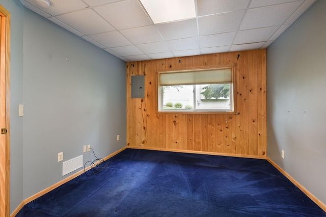 11102 16th St NE, Saint Michael, MN 55376 - spare room with wood walls, dark carpet, electric panel, and a paneled ceiling