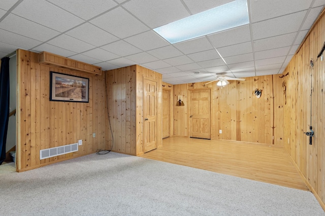 11102 16th St NE, Saint Michael, MN 55376 - basement with carpet floors, a paneled ceiling, and wooden walls