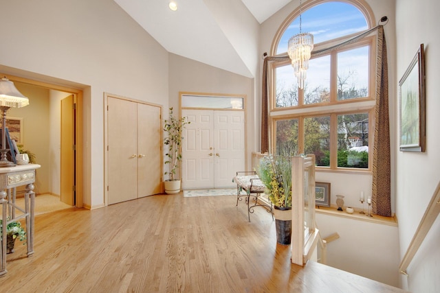 780 Virginia Shores Cir, Excelsior, MN 55331 - foyer entrance featuring high vaulted ceiling, a chandelier, light wood-style flooring, and plenty of natural light