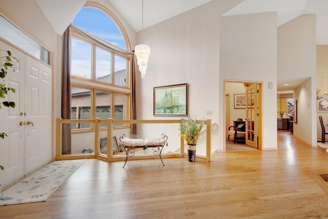 780 Virginia Shores Cir, Excelsior, MN 55331 - foyer entrance featuring high vaulted ceiling, wood finished floors, baseboards, and a chandelier