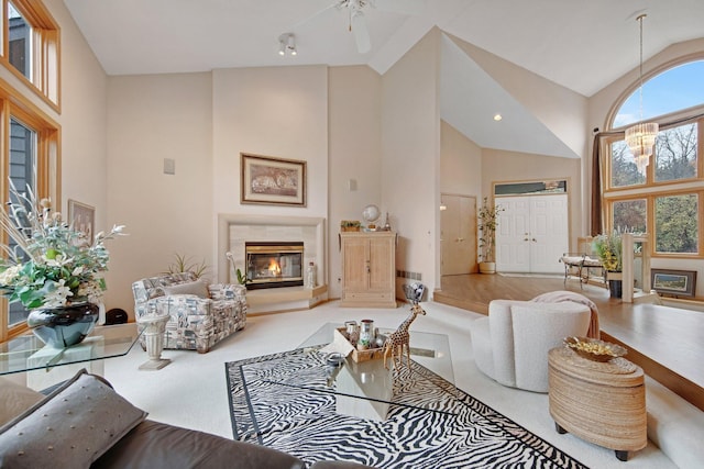 780 Virginia Shores Cir, Excelsior, MN 55331 - living room featuring a premium fireplace, high vaulted ceiling, a ceiling fan, and carpet floors