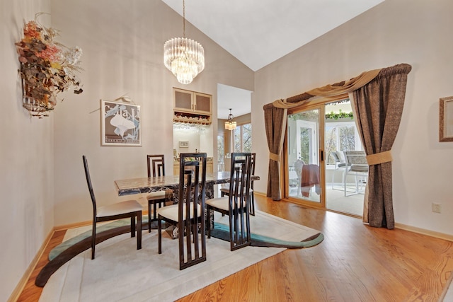 780 Virginia Shores Cir, Excelsior, MN 55331 - dining room with light wood finished floors, high vaulted ceiling, a chandelier, and baseboards