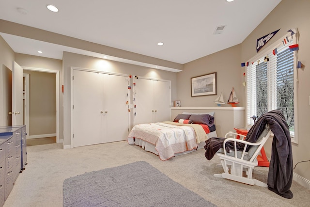 780 Virginia Shores Cir, Excelsior, MN 55331 - bedroom with recessed lighting, light carpet, multiple closets, multiple windows, and baseboards