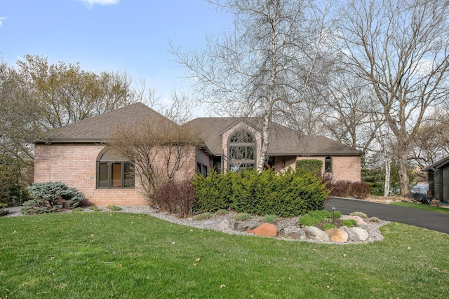 780 Virginia Shores Cir, Excelsior, MN 55331 - view of front of property with brick siding, a front yard, and a shingled roof