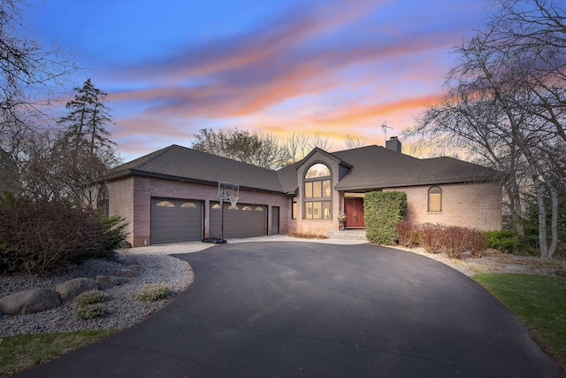 780 Virginia Shores Cir, Excelsior, MN 55331 - view of front facade featuring brick siding, asphalt driveway, an attached garage, and a chimney