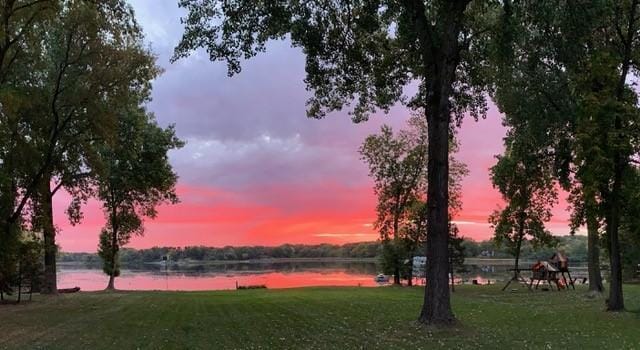 780 Virginia Shores Cir, Excelsior, MN 55331 - yard at dusk with a water view and a lawn