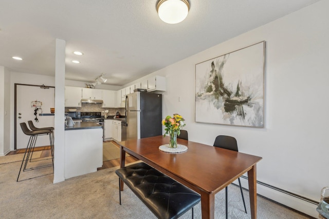 dining area featuring baseboard heating and recessed lighting