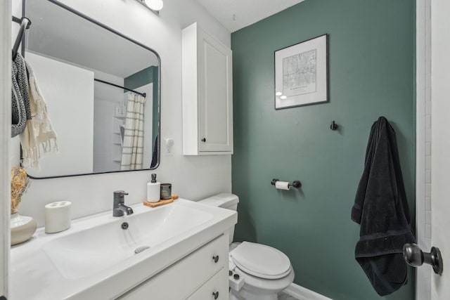 bathroom featuring baseboards, vanity, curtained shower, and toilet