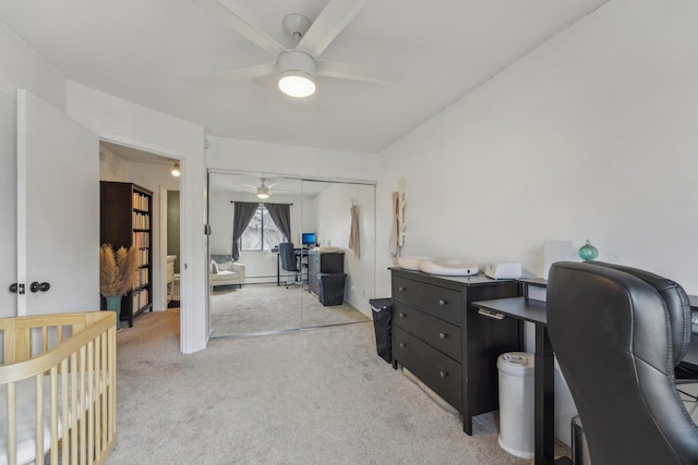 office area featuring light carpet and ceiling fan