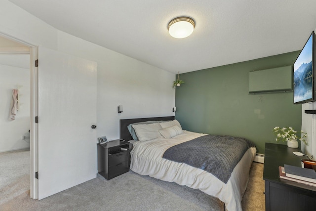 bedroom with baseboard heating and light colored carpet