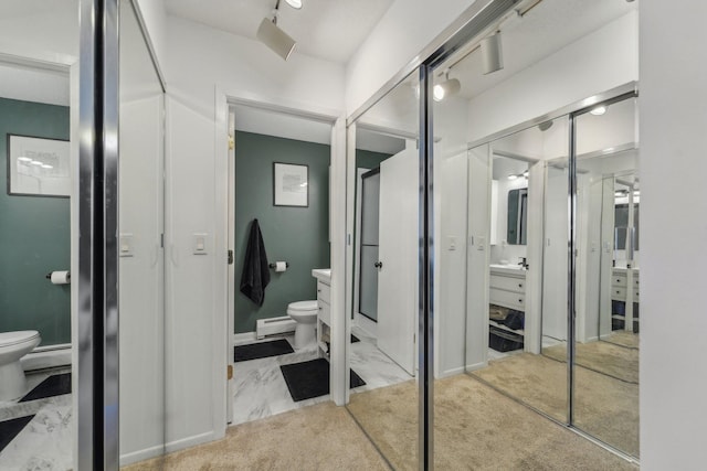 bathroom featuring vanity, a baseboard radiator, and toilet