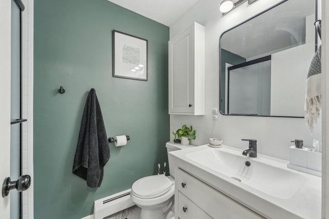 bathroom with baseboard heating, vanity, a shower with shower door, and toilet
