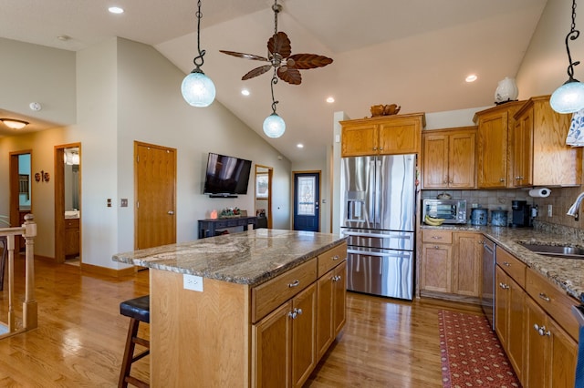 26141 Jonquil Ave, New Market Twp, MN 55020 - kitchen featuring stainless steel appliances, a sink, high vaulted ceiling, a ceiling fan, and a center island