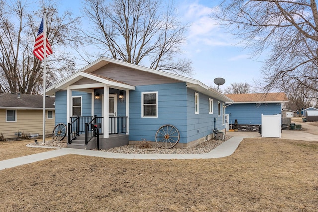 bungalow-style house with a front lawn