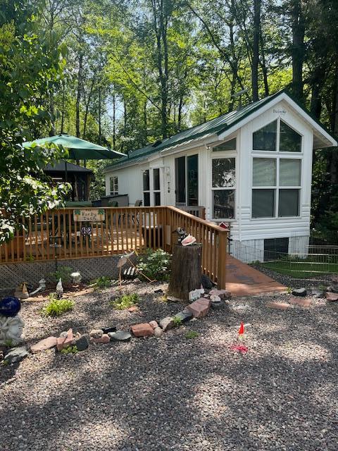 back of house featuring a wooden deck