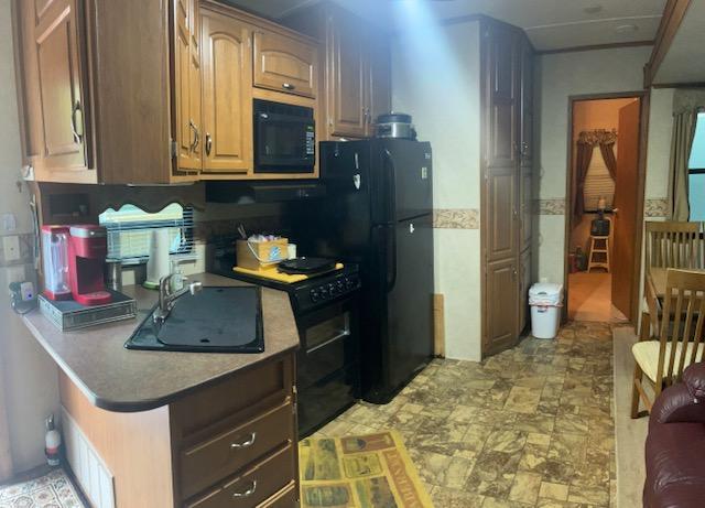 kitchen with a sink and black appliances